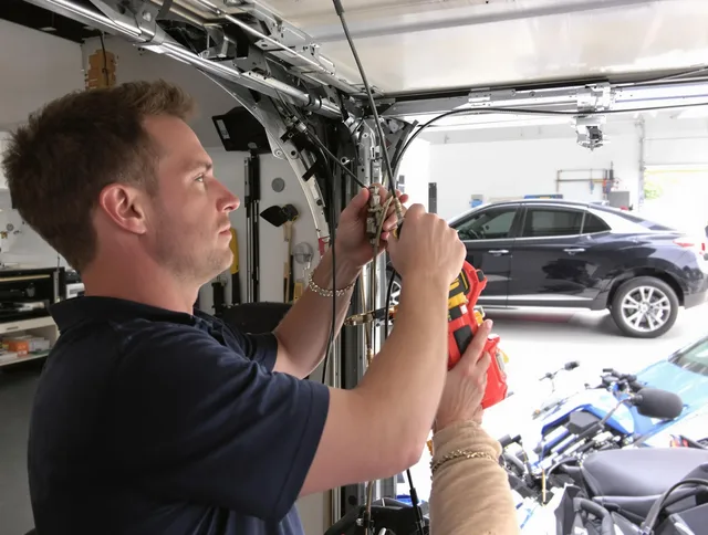 Farmington Garage Door Repair safety certified technician performing cable replacement in Farmington